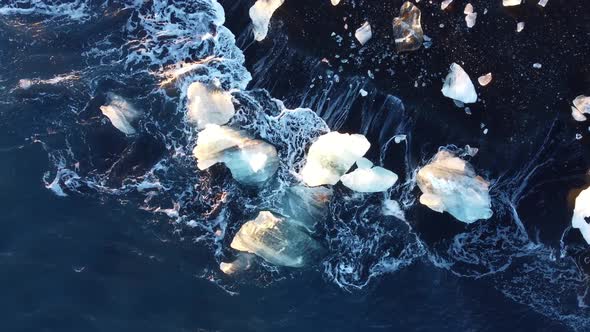 Waves Crashing Over Ice Formation Diamond Beach of the Breidamerkursandur Glacial Plain By