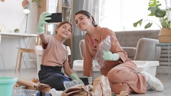 Girl and Her Mother Making Selfie while Segregating Waste