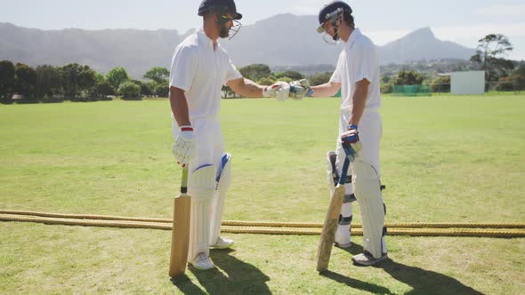 Cricket players doing a check on a pitch