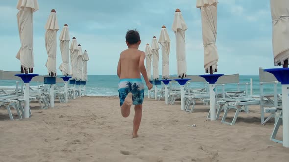 Active Teen Boy Running at Seaside