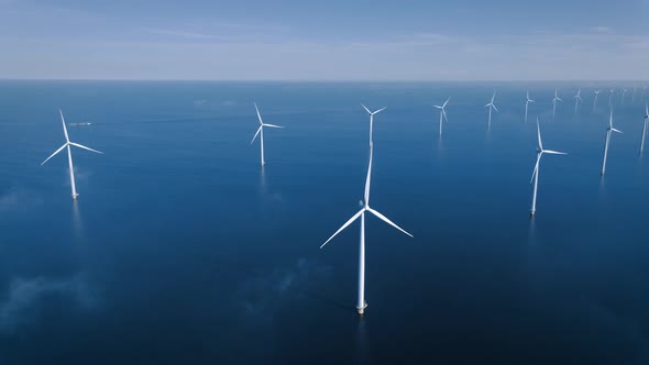 Offshore Windmill Park with Clouds and a Blue Sky Windmill Park in the Ocean Drone Aerial View with