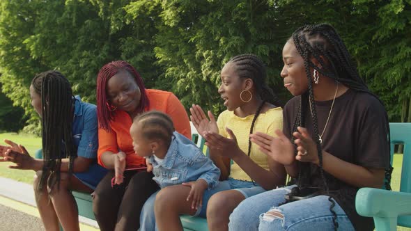 Joyful Black Family with Toddler Girl Having Fun Outdoors