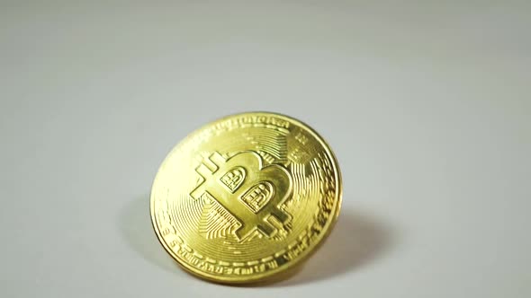 Close-up of slow motion of the Bitcoin cryptocurrency coin spinning against a white background