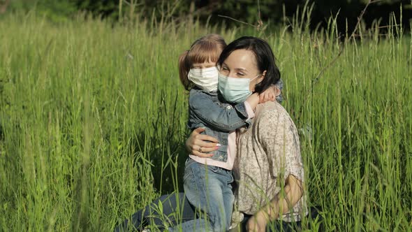 Family in Park Takes Off Medical Masks After Coronavirus Pandemic Quarantine End