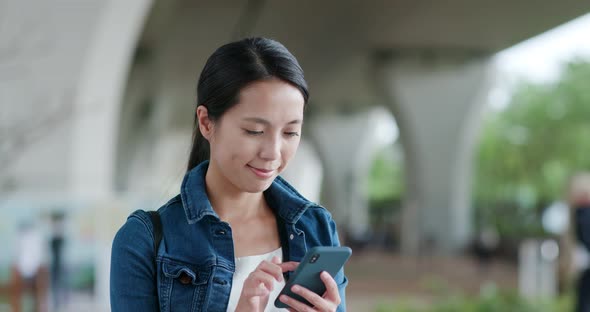 Woman use of smart phone in city