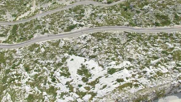 Aerial view of asphalt road curving on a hill