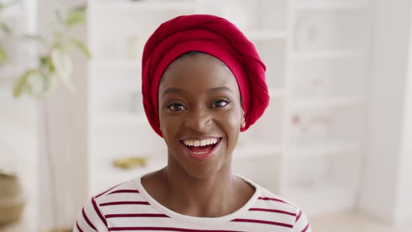 Portrait Of Happy African American Woman Wearing Headwrap At Home