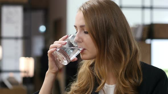 Drinking Water in Glass, Girl Sitting Indoor