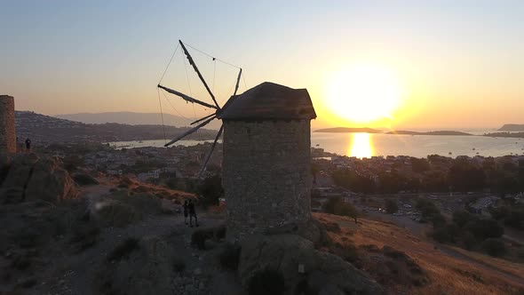 Old Traditional Historic Stone Windmill by the Sea at the Sunset