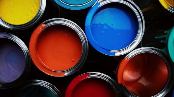 Aluminium Cans with Vivid, Colorful Paint Inside Stacked on the Floor of a Warehouse. Top View