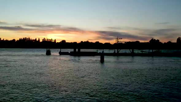 River dock silhouette in dusk light, slow pull back