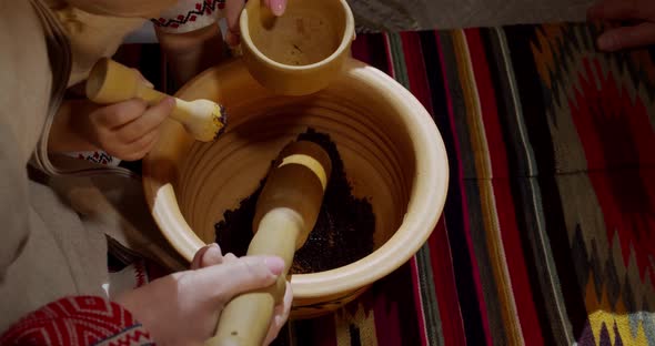 Ukrainian Traditions For Christmas. Stupa Grinds Poppy In A Clay Pot
