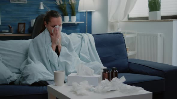 Adult with Seasonal Flu Bowing Runny Nose with Tissue