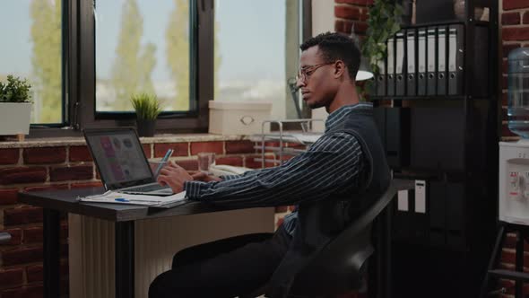 African American Person Working on e Commerce Statistics