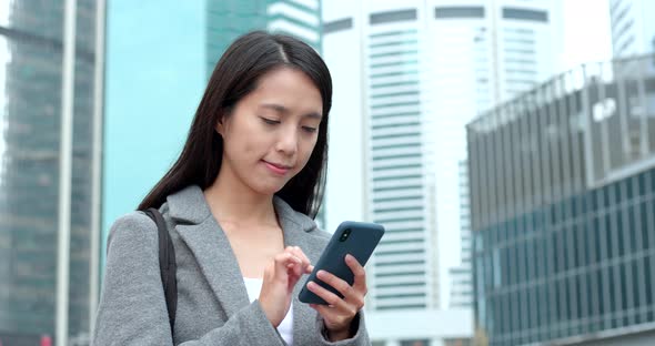 Businesswoman use of smart phone in city