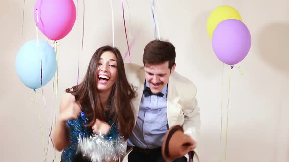 Woman and man having awesome time in photo booth