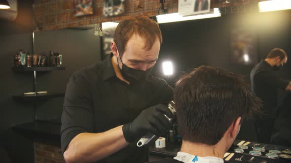 Barber Makes Hair Edging on the Sides of Client with a Hair Trimmer