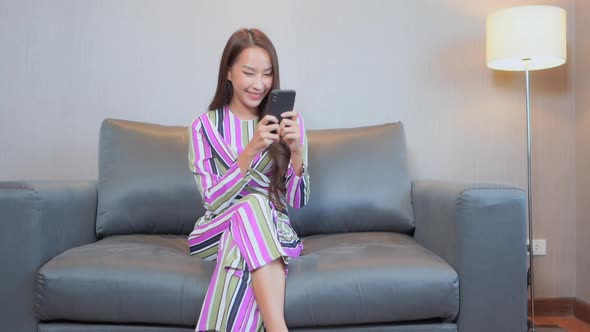 Young asian woman use smart phone in room