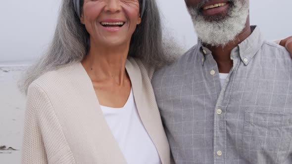 Mature couple enjoying time outside by the sea