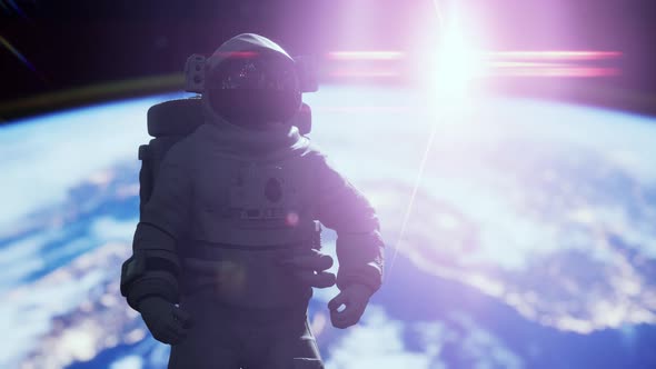 Space Man Astronaut in Space on a Background of the Blue Planet Earth alt