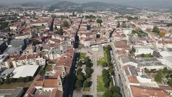 Aerial dolly in shot along Park Avenida Central toward republic square at downtown Braga city