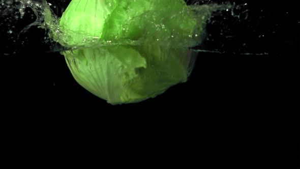 Super Slow Motion Forks of Fresh Cabbage Falls Under the Water with Air Bubbles