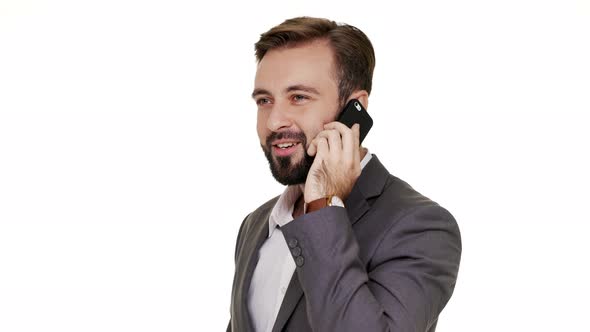 Portrait of Happy Brunette Man in Business Outfit Holding Smartphone in Hand Having Pleasant Mobile