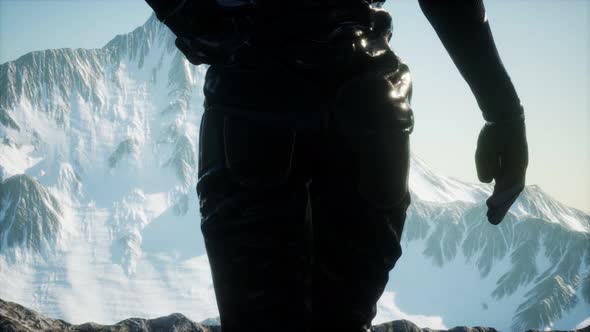 Woman Standing In Snow Wearing Warm Clothes In Mountains alt