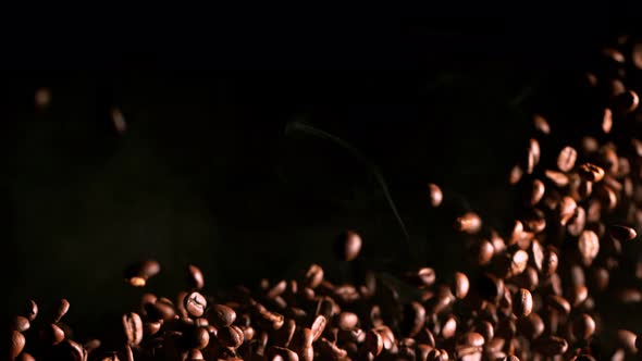 Super Slow Motion Shot of Exploding Premium Coffee Beans and Smoke Isolated on Black at 1000Fps