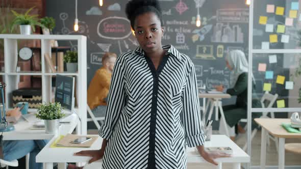 Slow Motion Portrait of Beautiful Young African American Woman Standing in Office