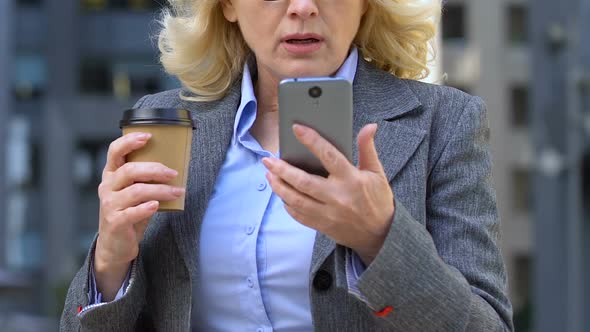 Aged Lady Using Cell Phone at Coffee Break, Dissatisfied With Business App