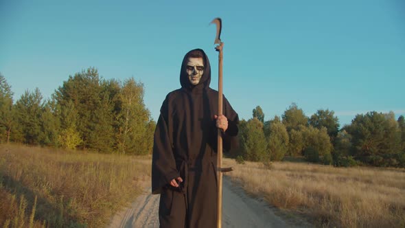 Death Reaper Frightening with Scythe on Dirt Road