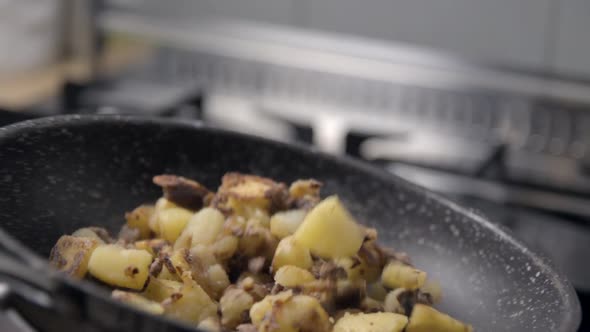 Potatoes and meat cooking slowmotion