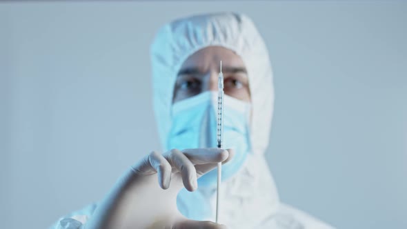 close-up of doctor with vaccine syringe in front of face