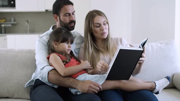 Cheerful Parents and Little Black Haired Daughter