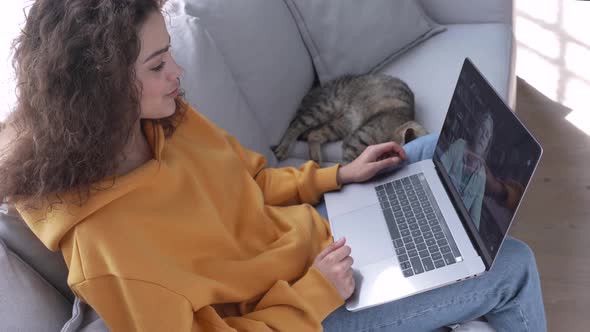 Smiling Hispanic Girl at Home with Cat Hold Laptop Talk By Webcam Video Call