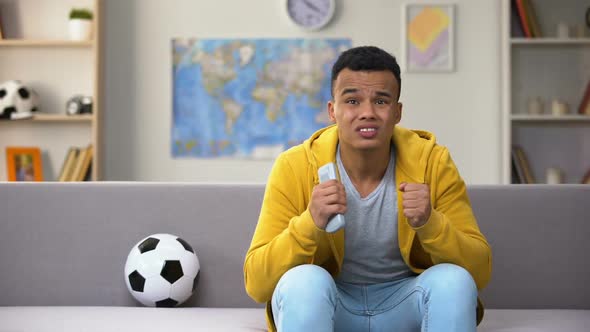 Emotional African-American Teenager Watching Football Match on TV, National Team