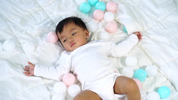 slow-motion of baby lying on a bed