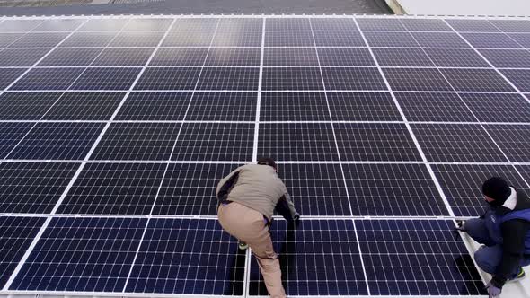 Solar Technician Installing Solar Panels on House Roof