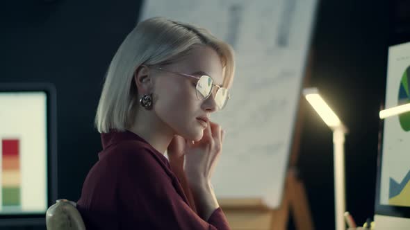 Overworked Business Woman Fixing Earring Front Computer in Night Office