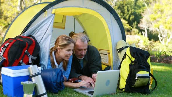 Happy hiker couple using laptop