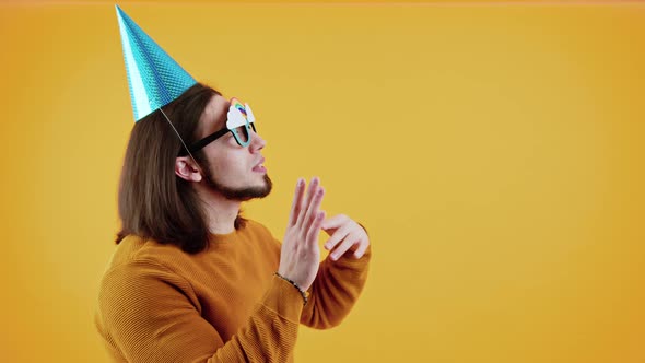 Funny Caucasian Middleaged Bearded Man Dancing While Wearing Giant Birthday Cup and Unusual Glasses