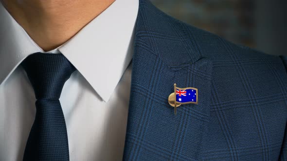 Businessman Walking Towards Camera With Country Flag Pin Australia