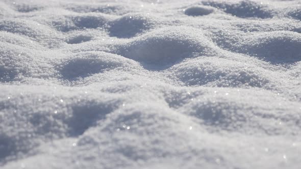 Crystals of shiny snow forming dunes 4K 2160p 30fps UltraHD tilting  footage - Shallow DOF clear whi