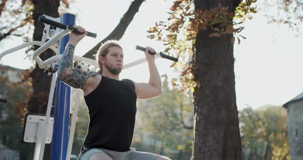 Young Muscular Guy Training His Arms to be Strong