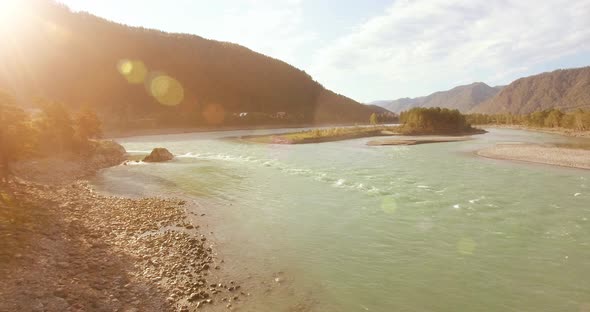 Low Altitude Flight Over Fresh Fast Mountain River with Rocks at Sunny Summer Morning