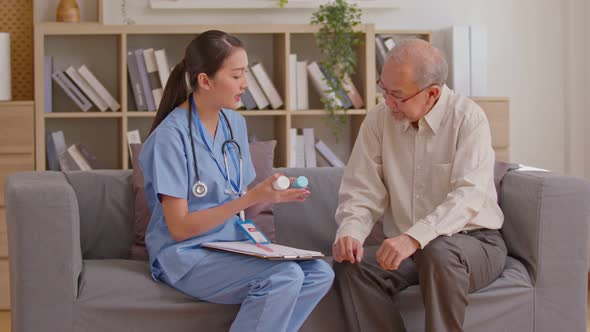 Senior elder man patient talking to caring female doctor physician caregiver at nursing home in hosp