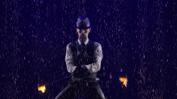 An Enchanting Show of Fire in Rain and Water Drops Performed By a Stylish Man. Smoky Studio