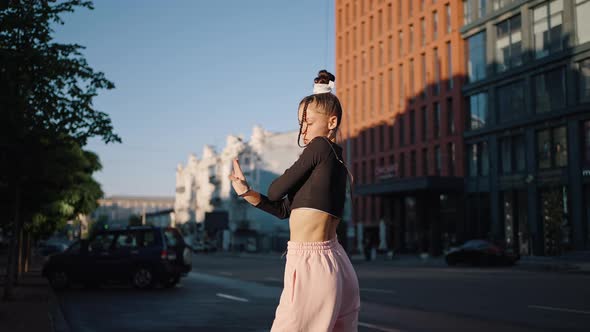 Young Stylish Woman Dancer Shows Hands Moves at Sunlight