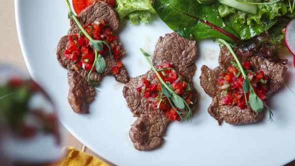 Chopped beef meat with tartar sauce served on white plate in restaurant